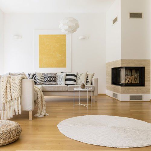 Spacious white and wooden living room with modern fireplace and sofa