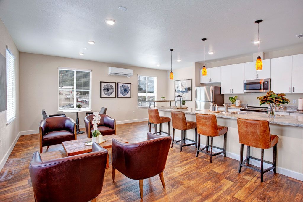 A living room filled with furniture and a kitchen in a house.