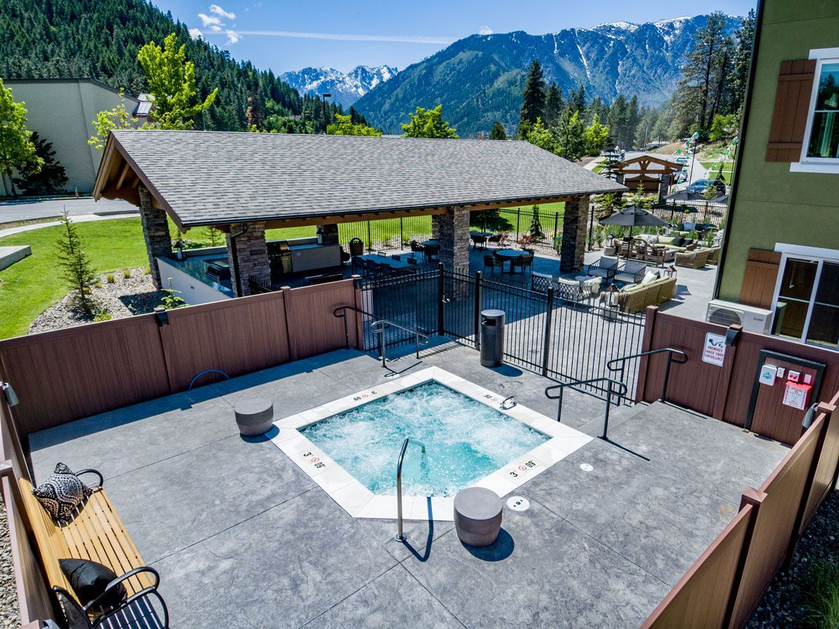 An aerial view of a hot tub with mountains in the background.