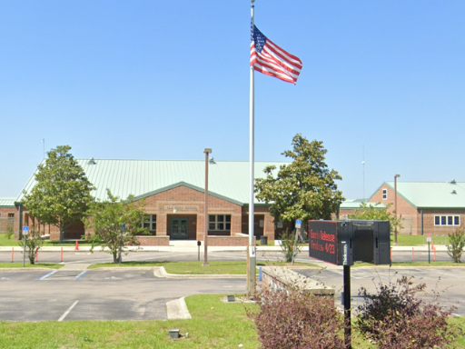 an american flag is flying in front of a building