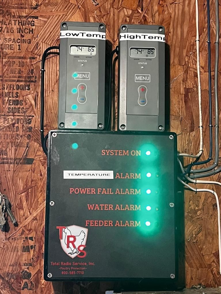 A box with a lot of buttons on it is hanging on a wall.