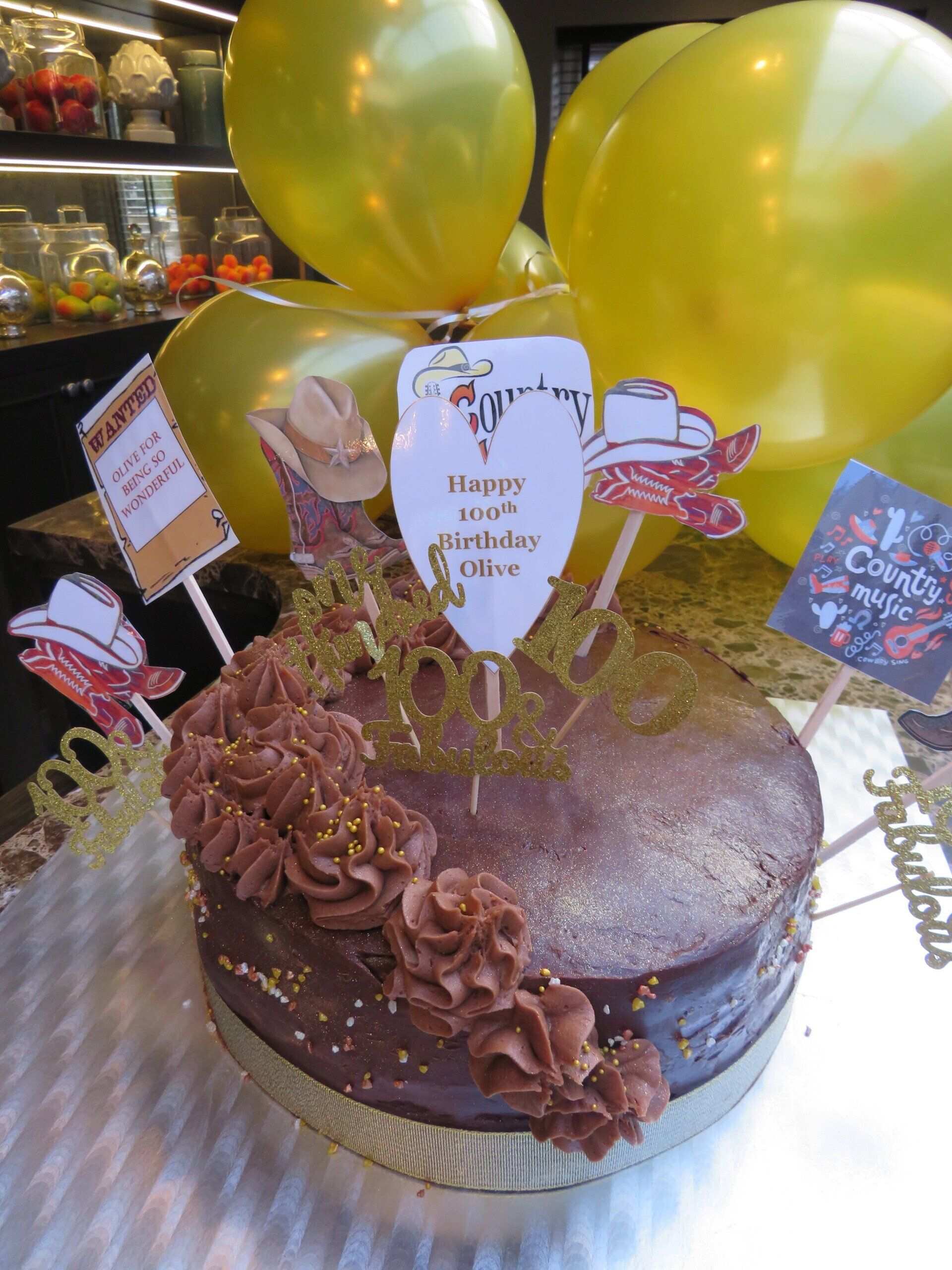 A cake with a sign that says happy birthday on it