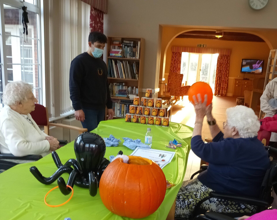 Lincoln House Residents Playing Ball Toss Game During Halloween