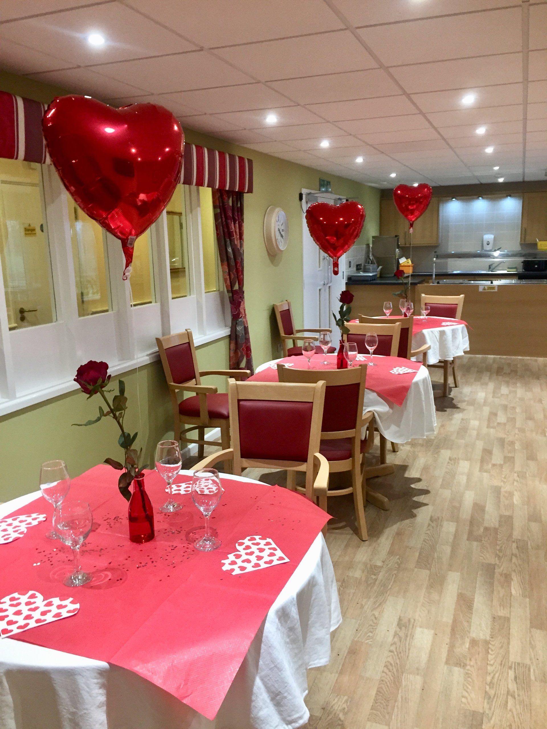 A dining room with tables and chairs decorated for valentine 's day