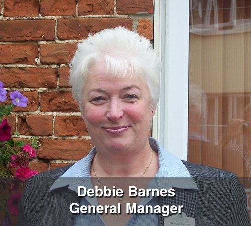 A woman with the name debbie barnes on her shirt