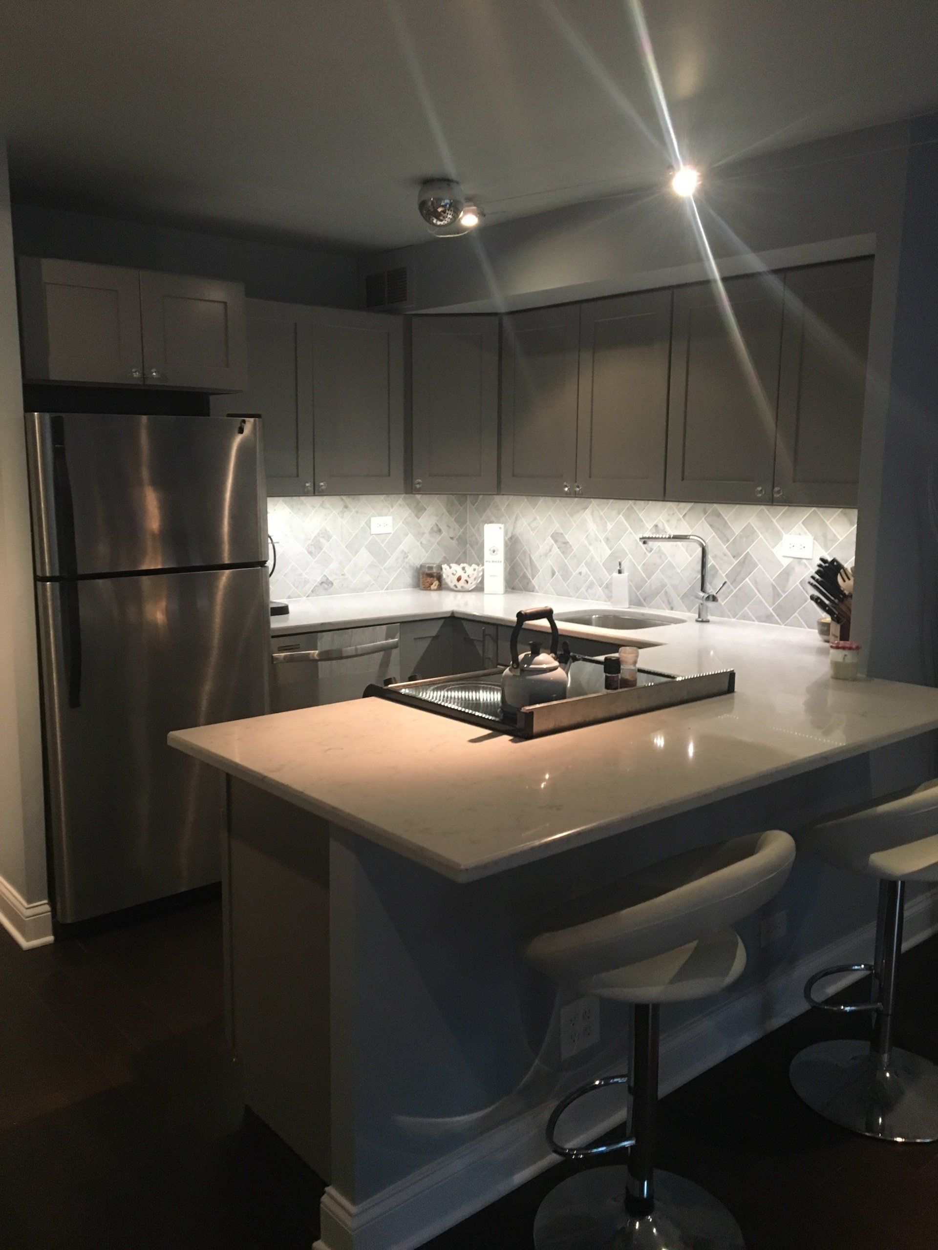 A kitchen with stainless steel appliances including a refrigerator
