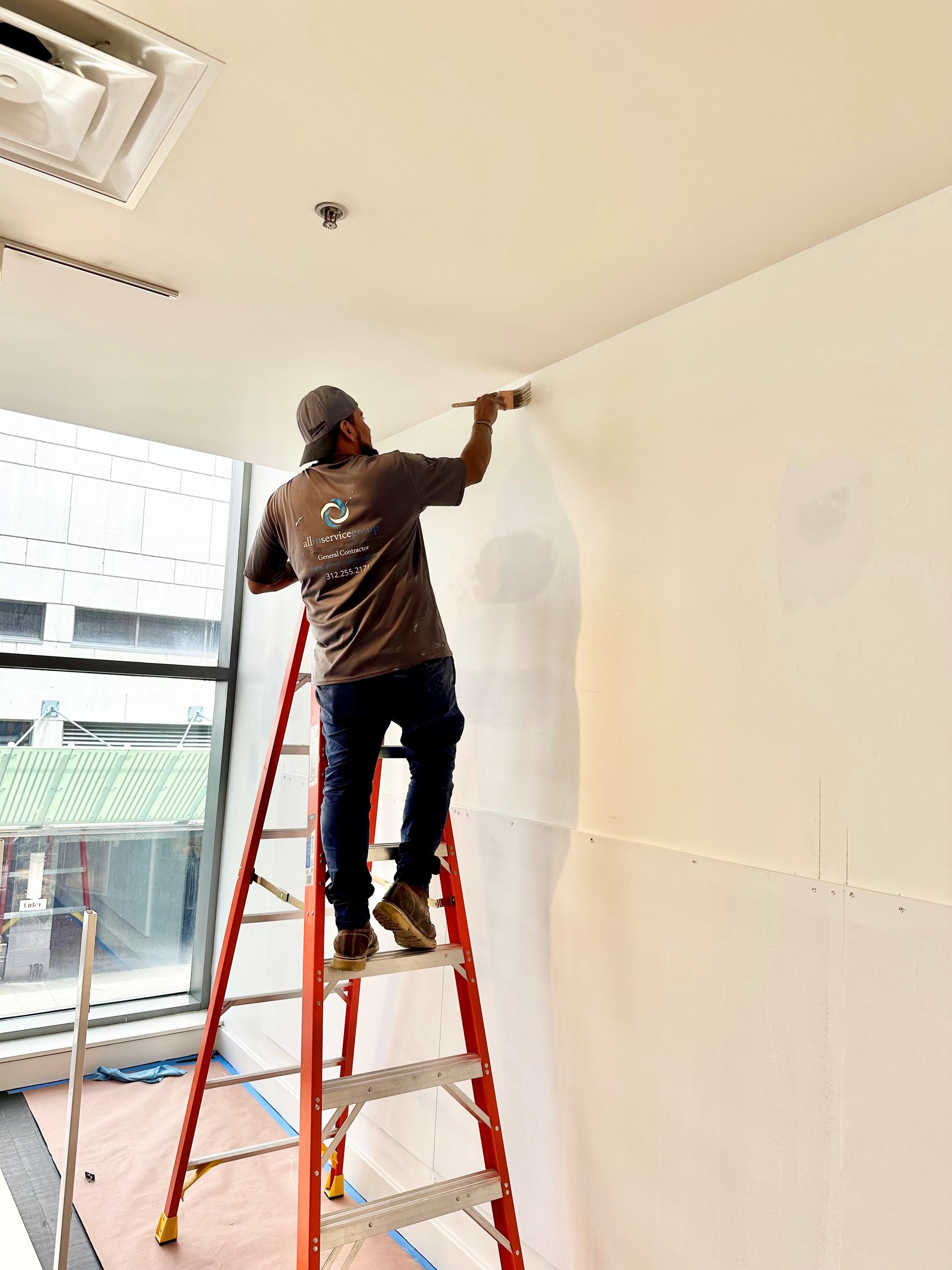 A black and white rug is on the floor in front of a window