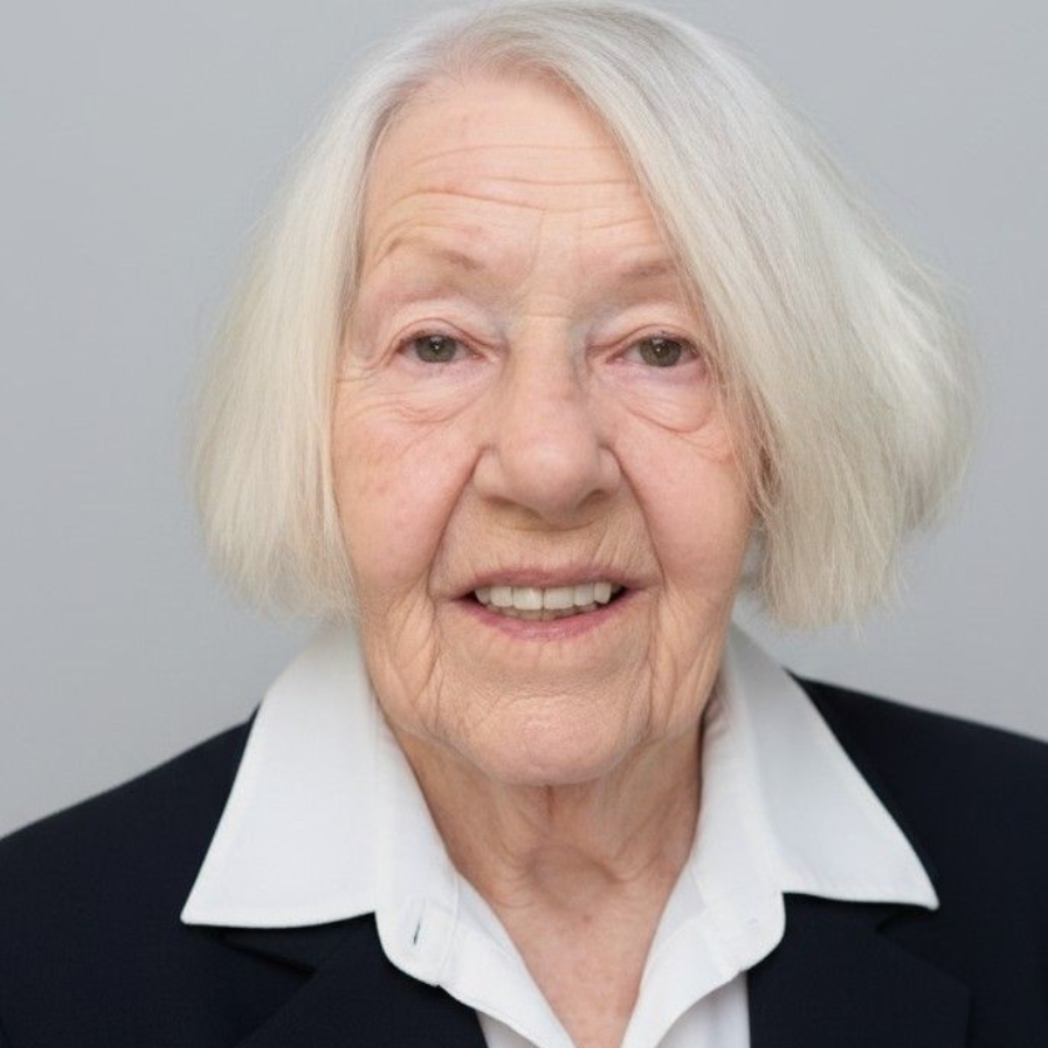 A man in a plaid shirt is smiling for the camera.