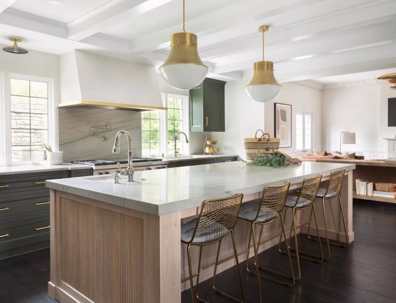 A kitchen with a large island and stools