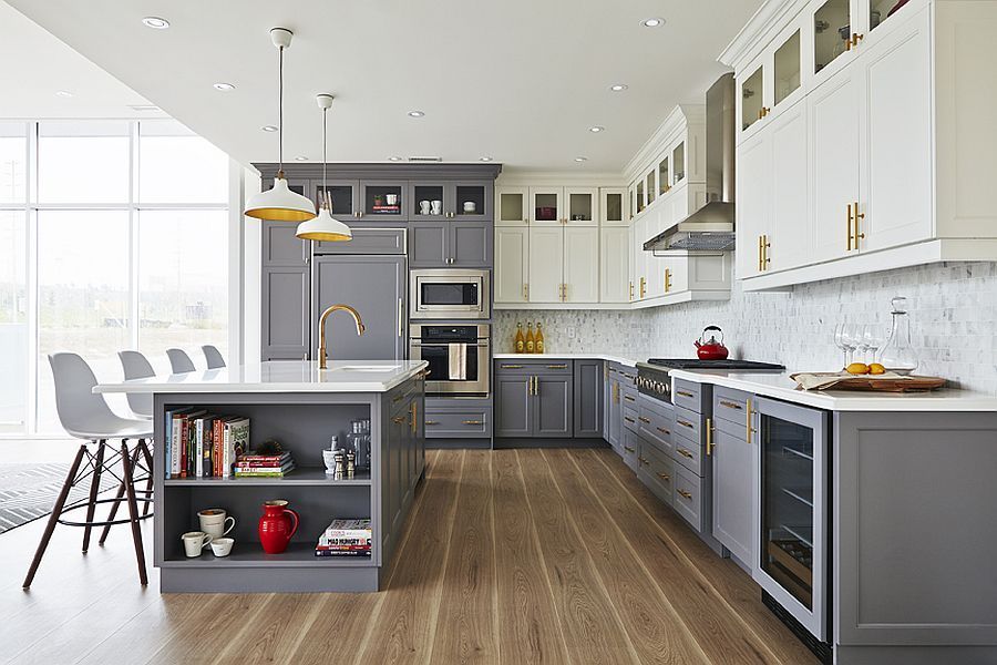Modern white-and-gray kitchen with island, pendant lights, wooden floor, and bar stools by a large window