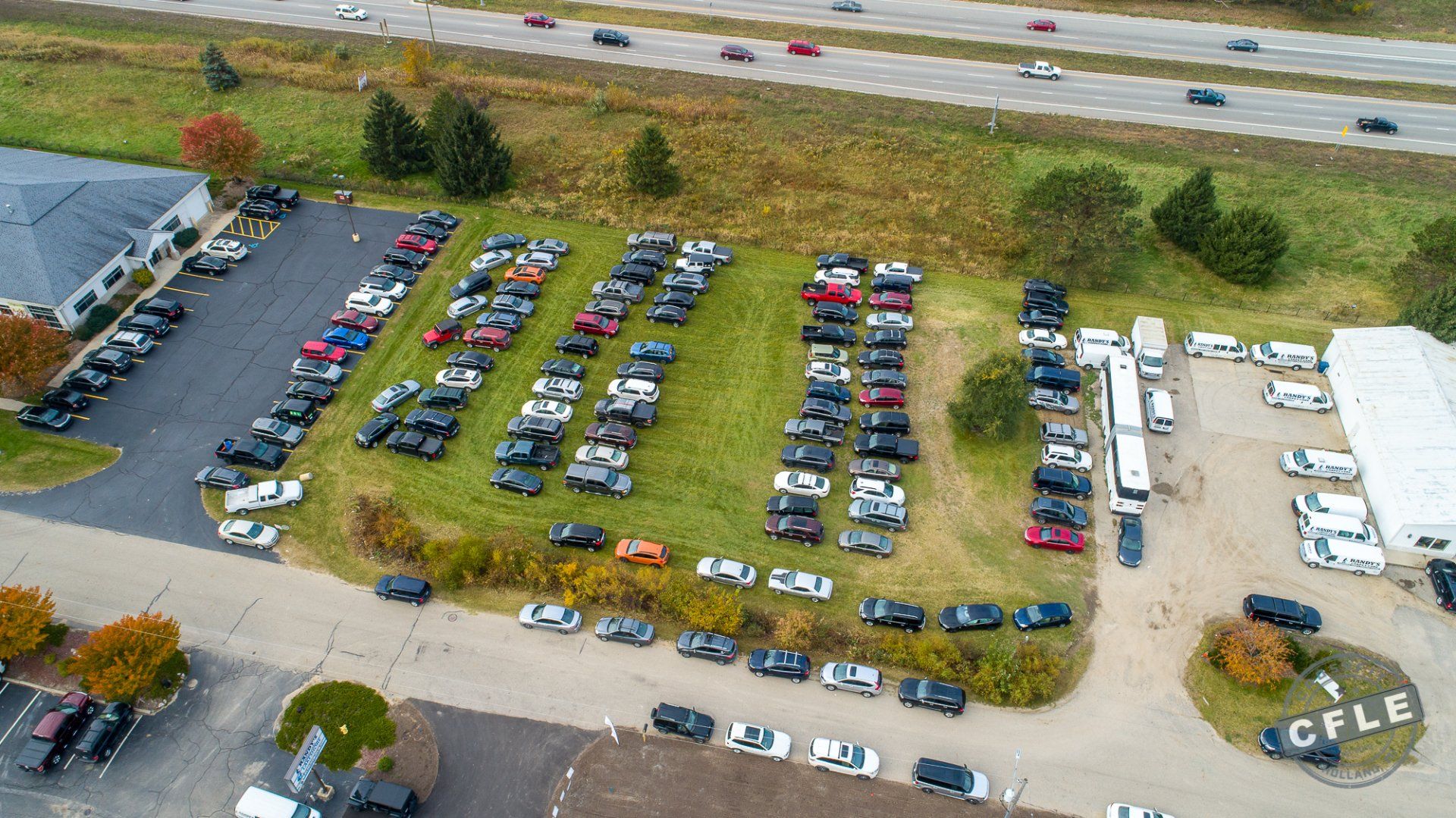 An aerial view of a parking lot filled with cars.