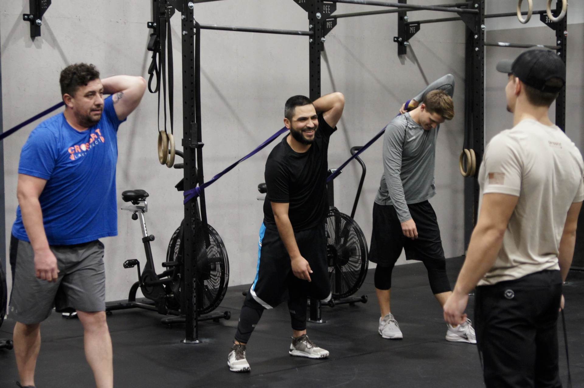 A group of men are doing exercises in a gym.