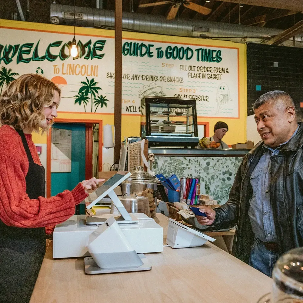 a man is paying for products in a shop