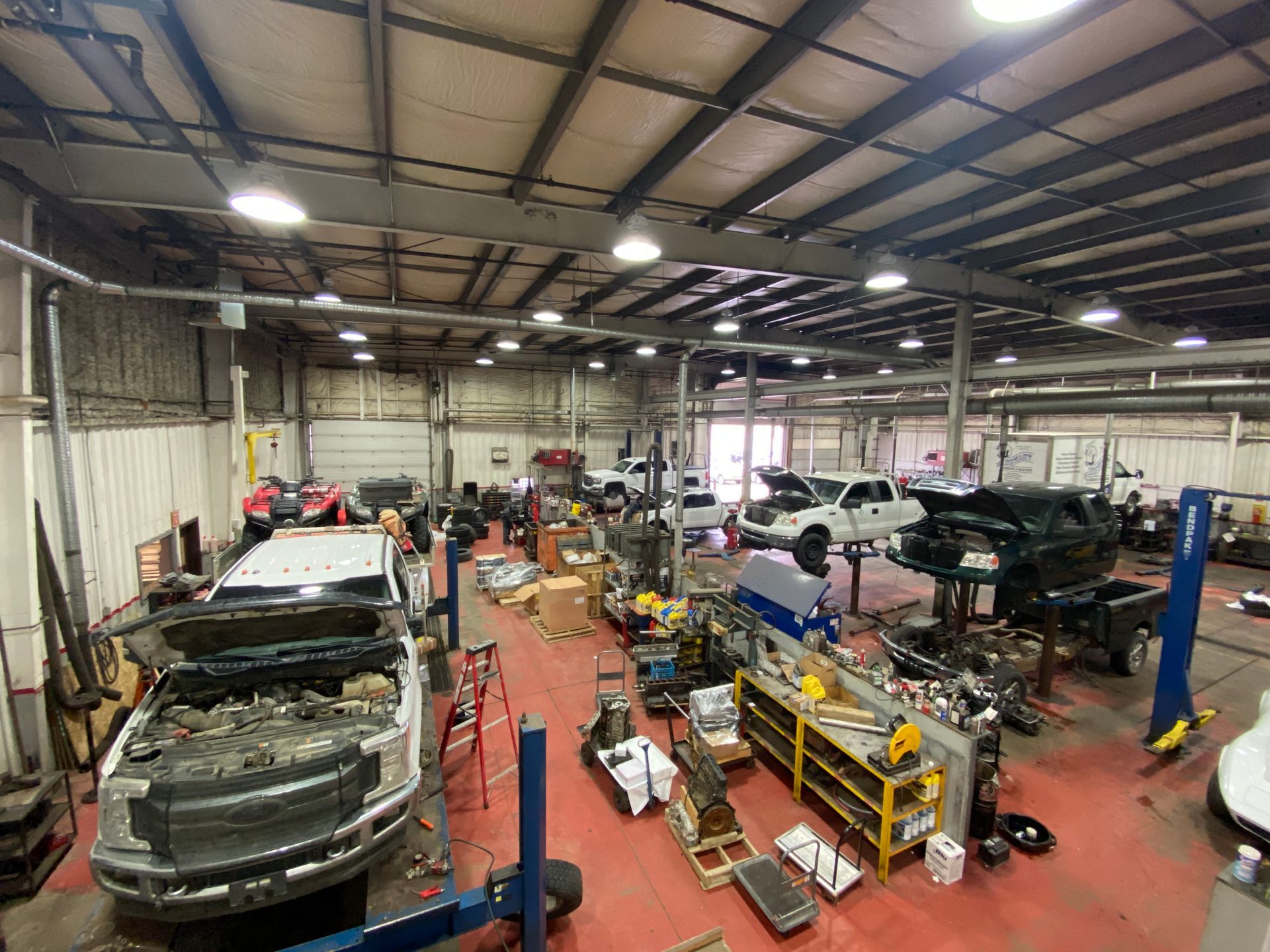 A large garage filled with lots of cars and trucks being worked on | Cetus Automotive Repair Centre