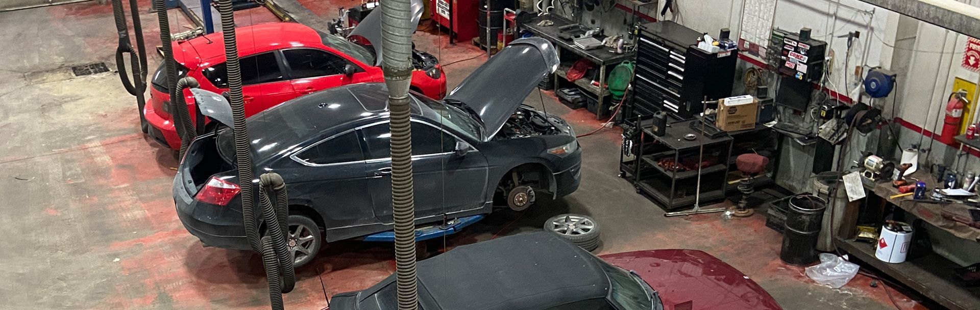 A group of cars are being worked on in a garage | Cetus Automotive Repair Centre