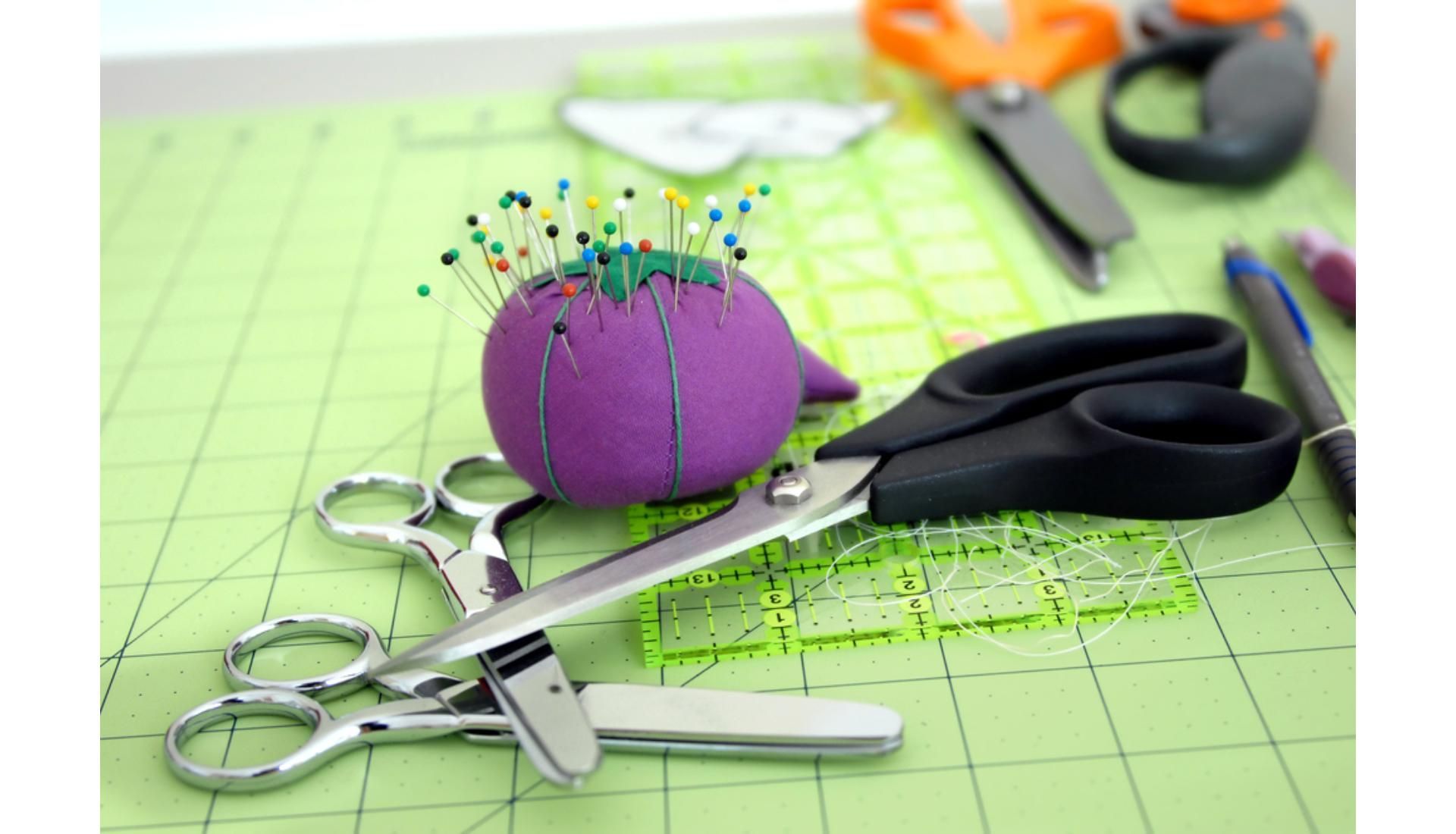 A Purple Pincushion And Scissors Are On A Cutting Mat — Macquarie Dry Cleaners In Dubbo, NSW