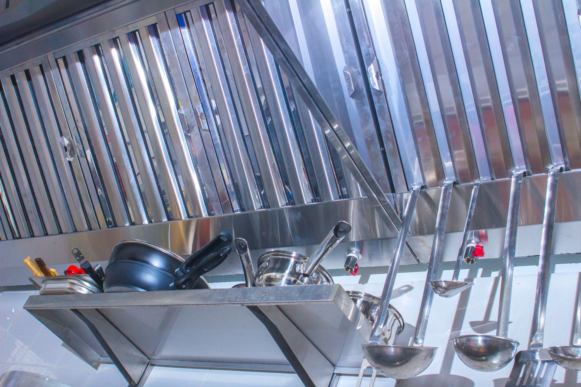 Professional hood in a restaurant kitchen made of stainless steel with galvanized duct. Professional hood in a restaurant kitchen made of stainless steel with galvanized duct.