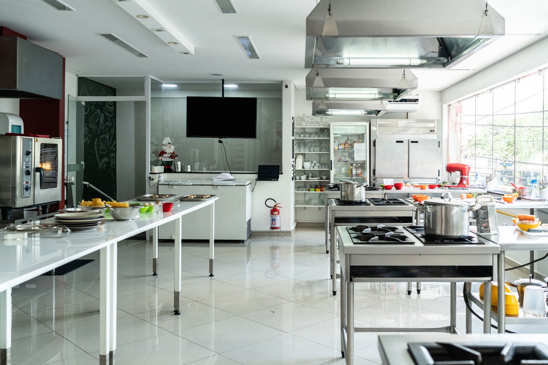 View of a pristine and degreased white commercial kitchen.