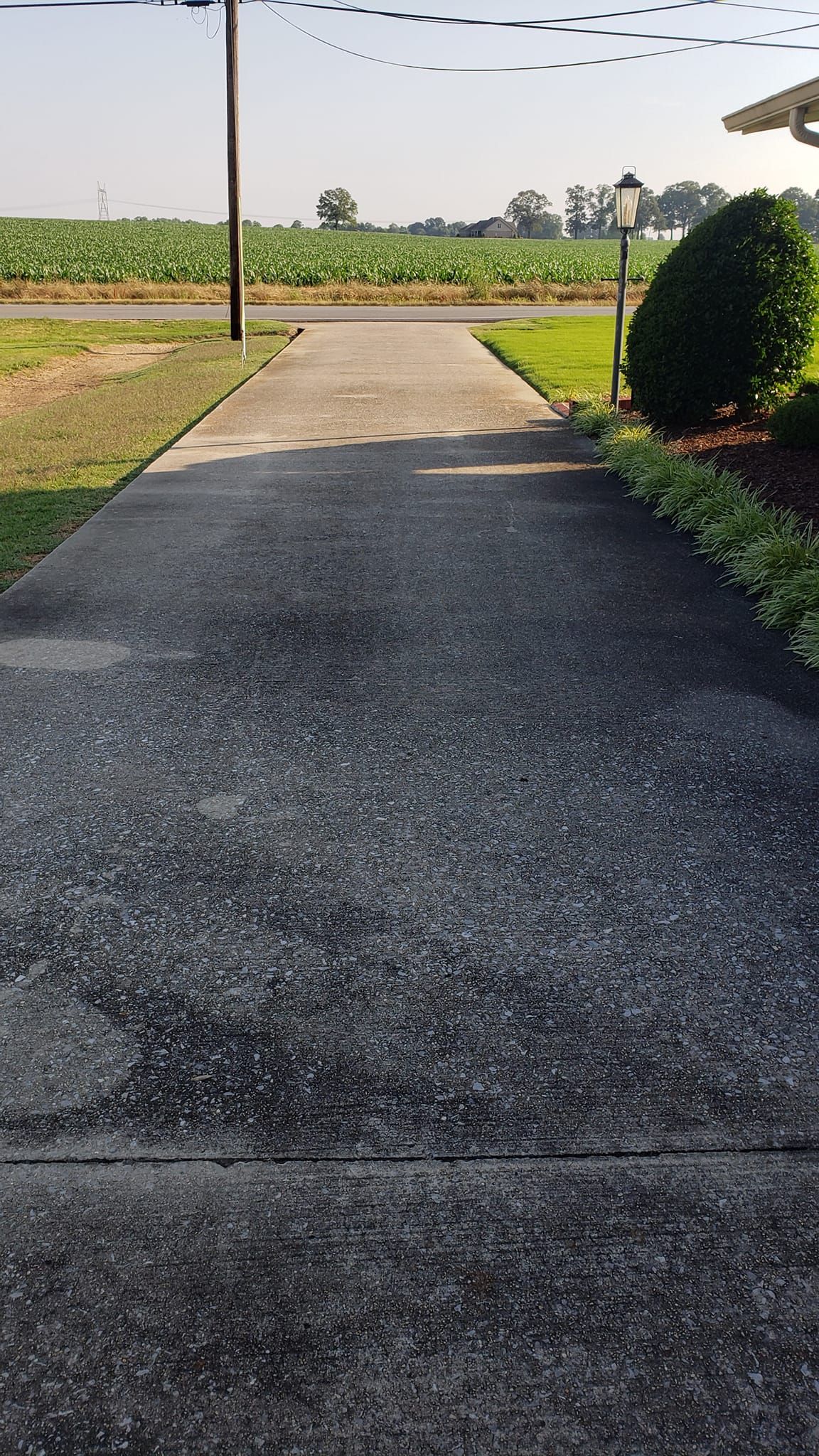 Before Power Washing Driveway In Front of Field and Utility Pole | Harvest, AL | Radiant Exterior Cleaning