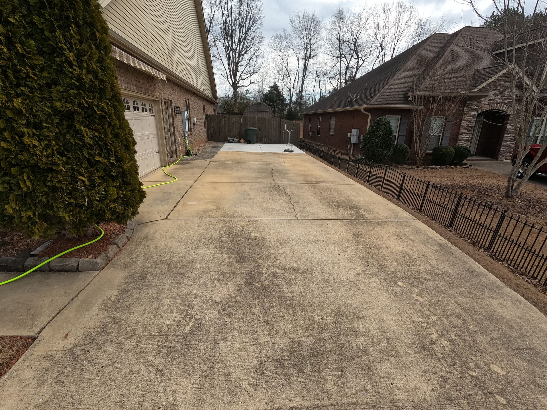 Before Driveway Power Wash Home Metal Fence | Harvest, AL | Radiant Exterior Cleaning