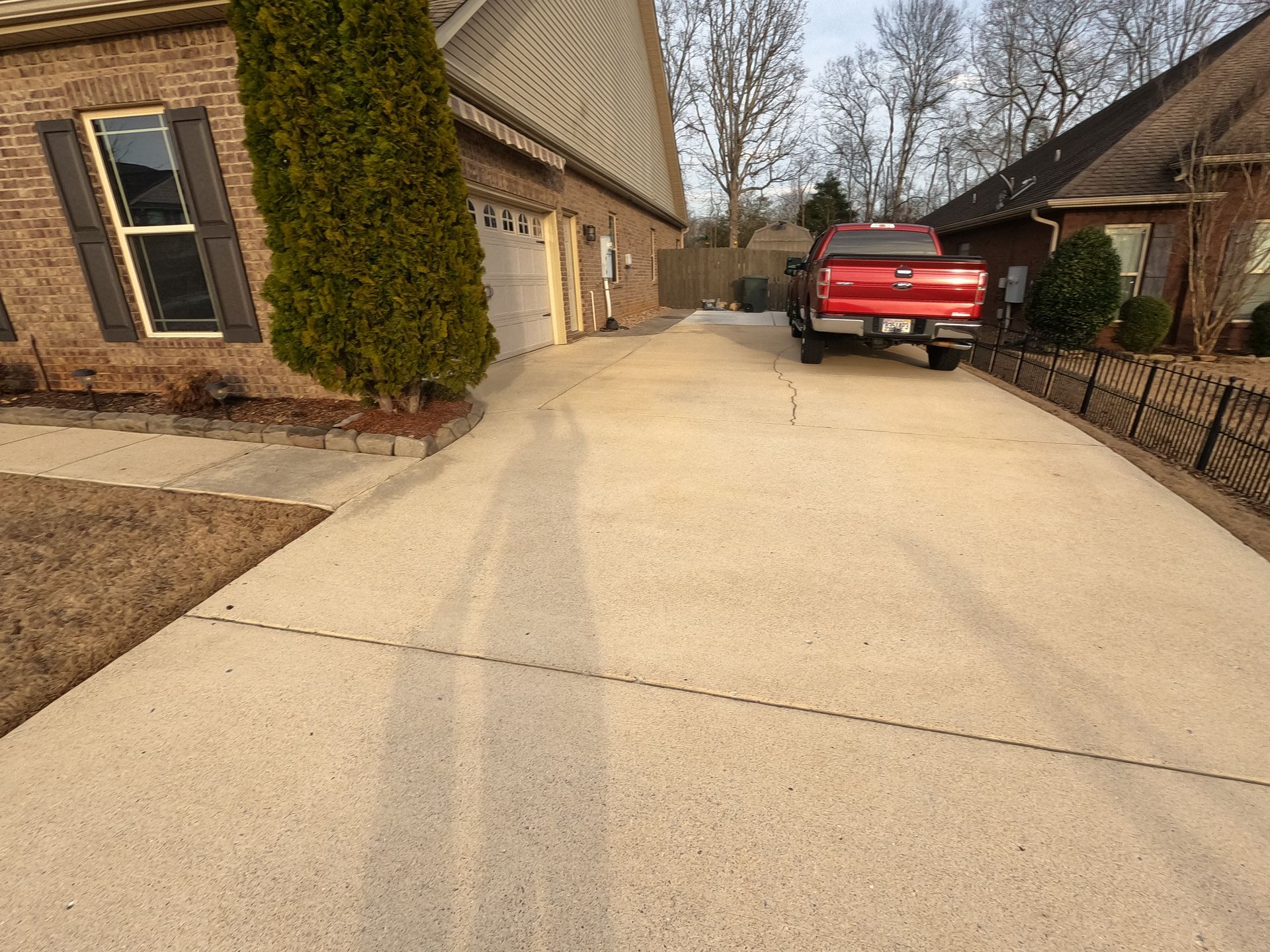 After Driveway Power Wash Home Metal Fence With Red Truck | Harvest, AL | Radiant Exterior Cleaning