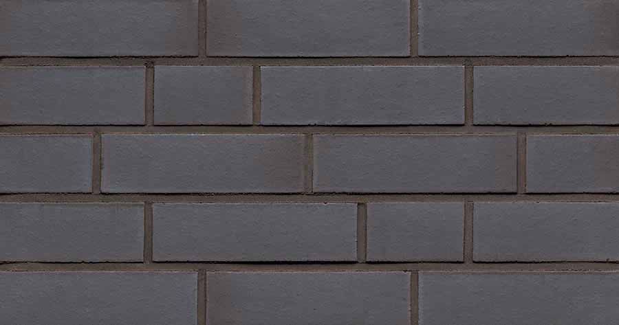 Dark gray brick wall with mortar joints.