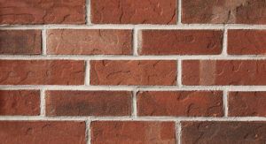 Red brick wall with white mortar.