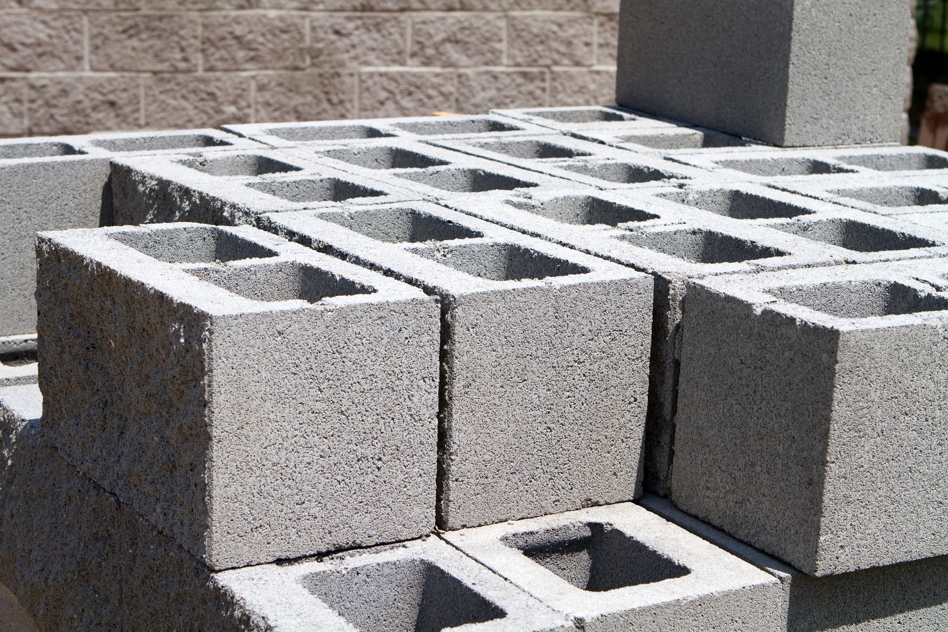 Gray concrete retaining wall built on a hillside.