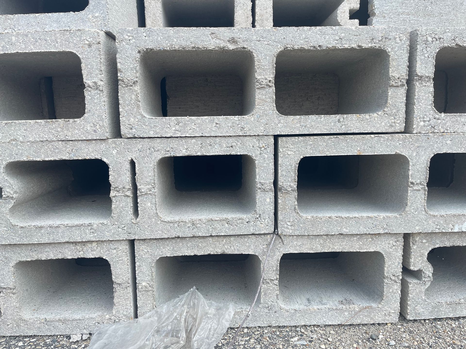 Stack of gray concrete blocks with rectangular openings.