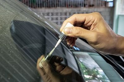 Mechanic Using Glue Welding Cracked Windscreen — Long Beach, CA — Glass-Man Glass Company