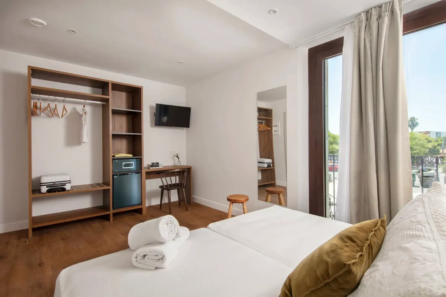 A hotel room with a large bed and a large window.