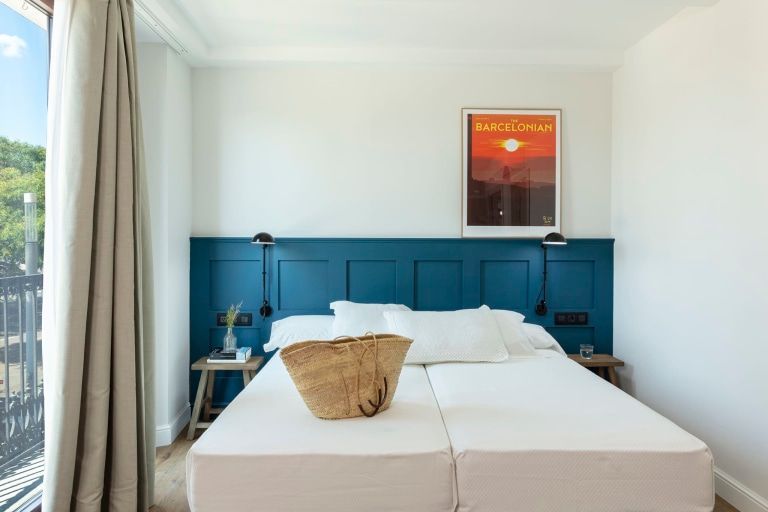 A bedroom with a bed and a picture on the wall.