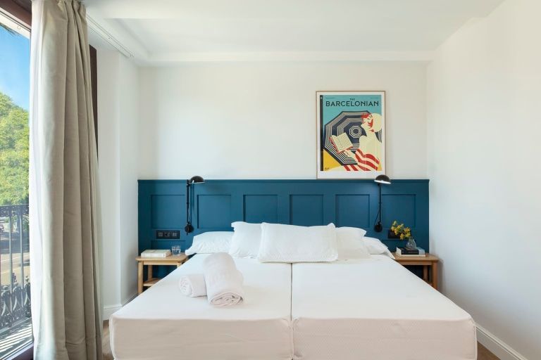 A bedroom with a large bed and a blue headboard