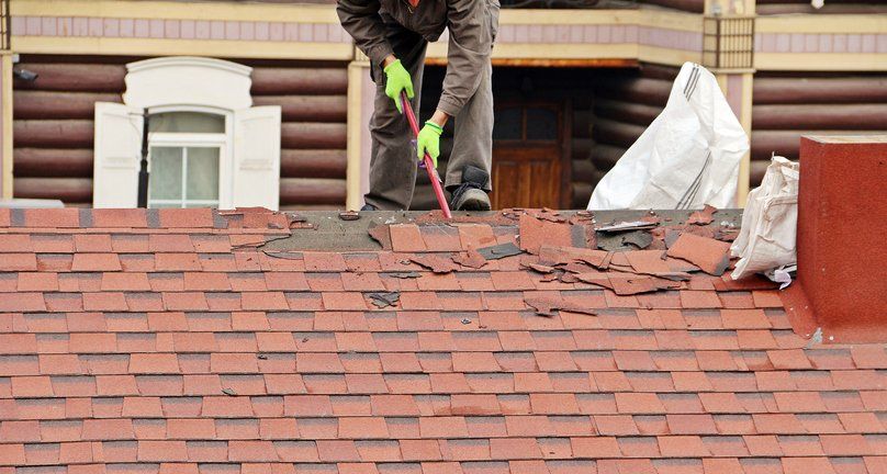 Asphalt Shingles — Worker Repairing Roof in West Boylston, MA