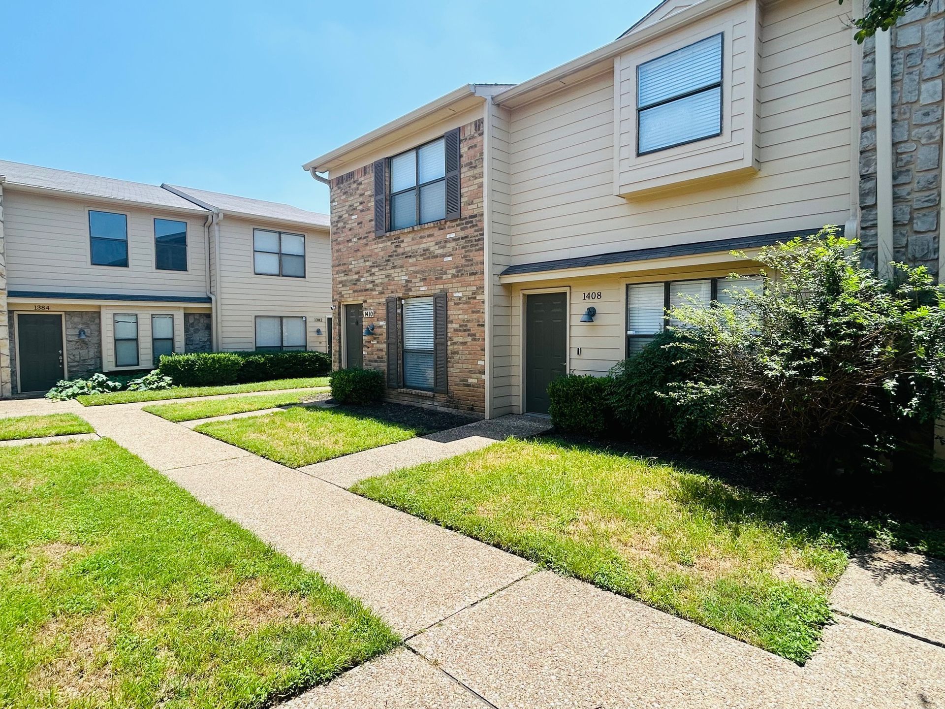 A row of apartment buildings with a walkway leading to them
