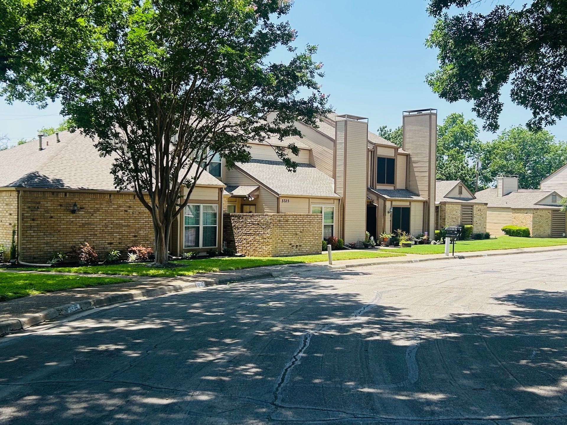 A house with a lot of trees in front of it