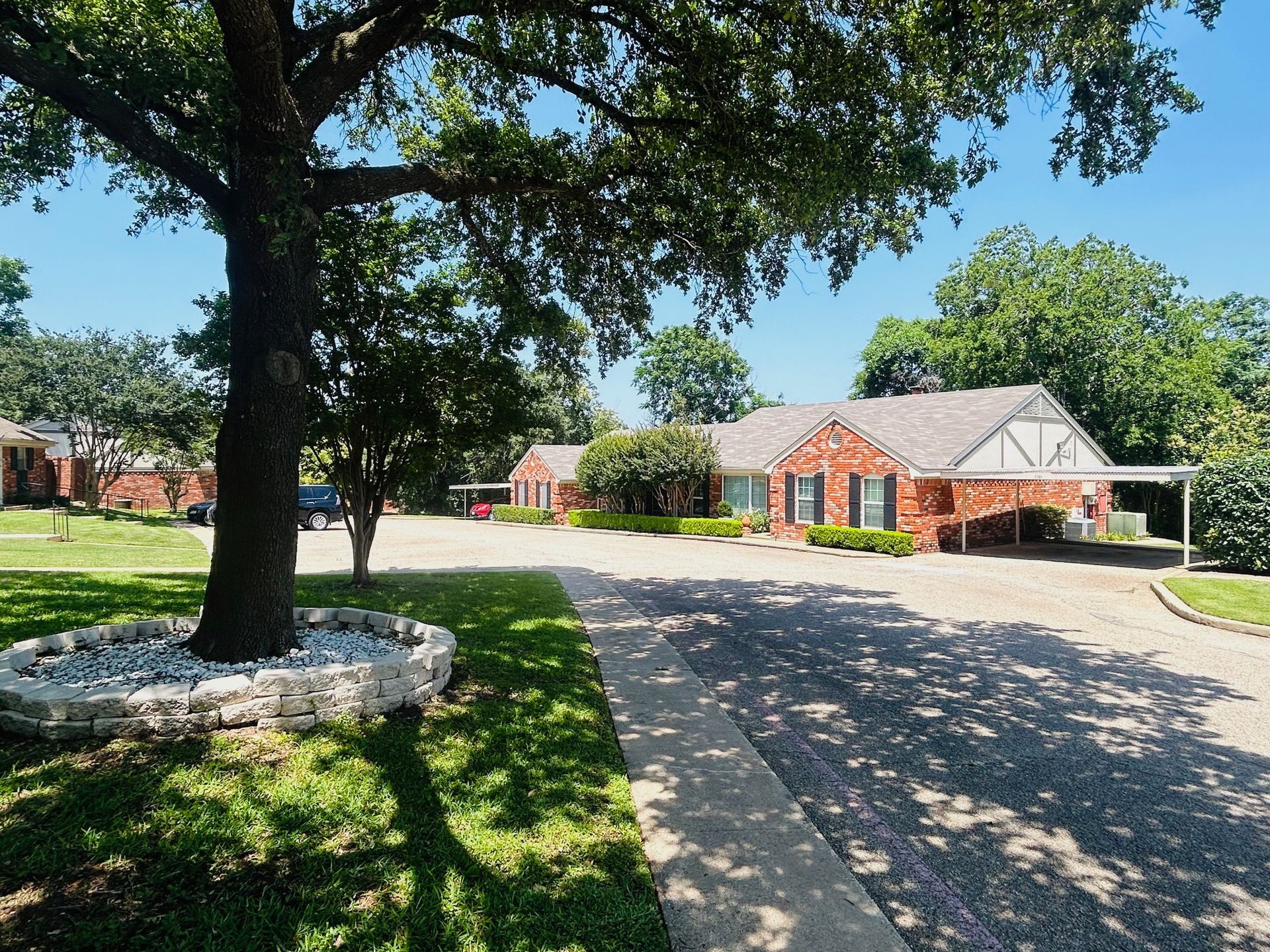 A brick house with a tree in front of it