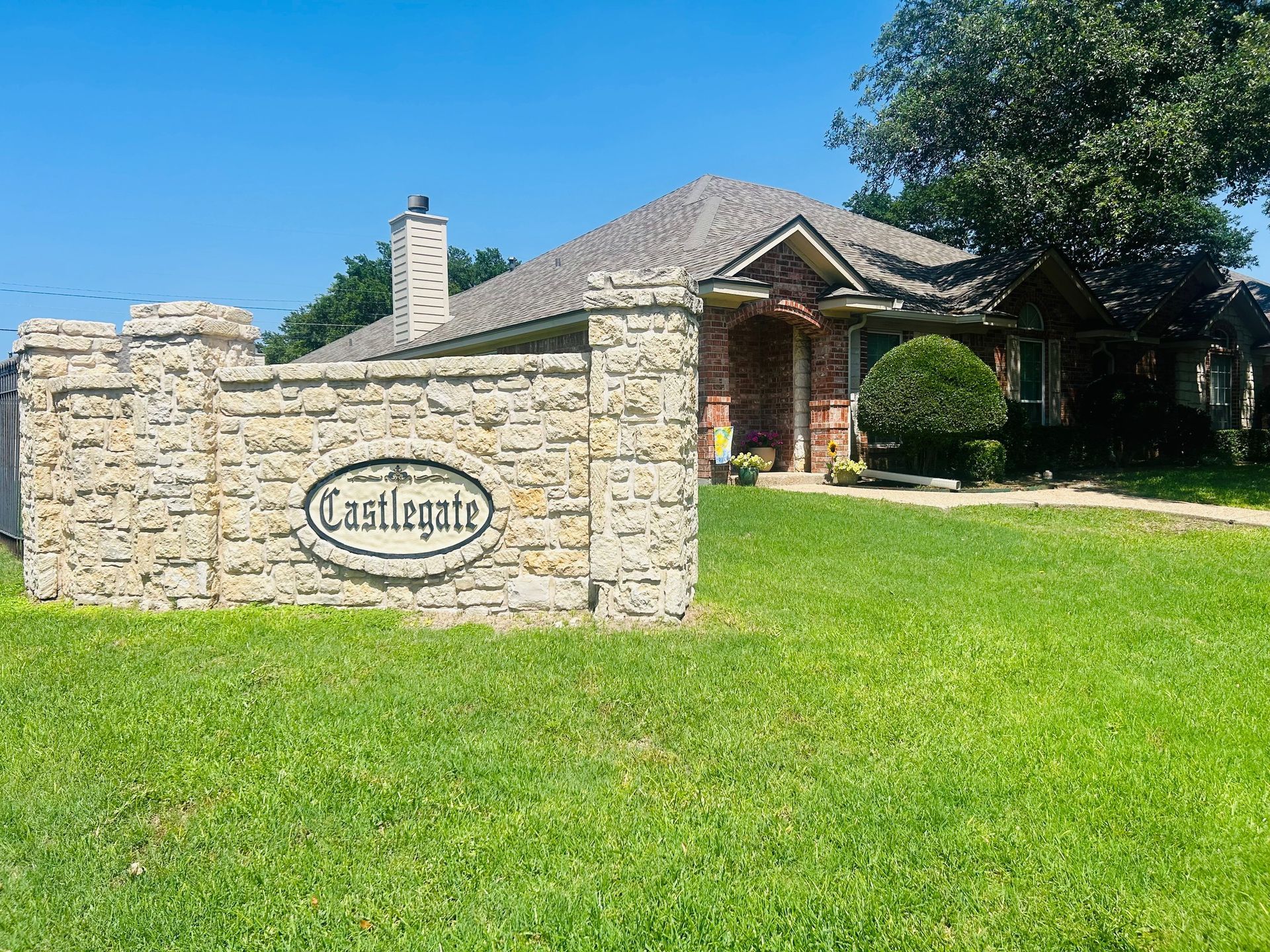 A house with a stone sign in front of it.
