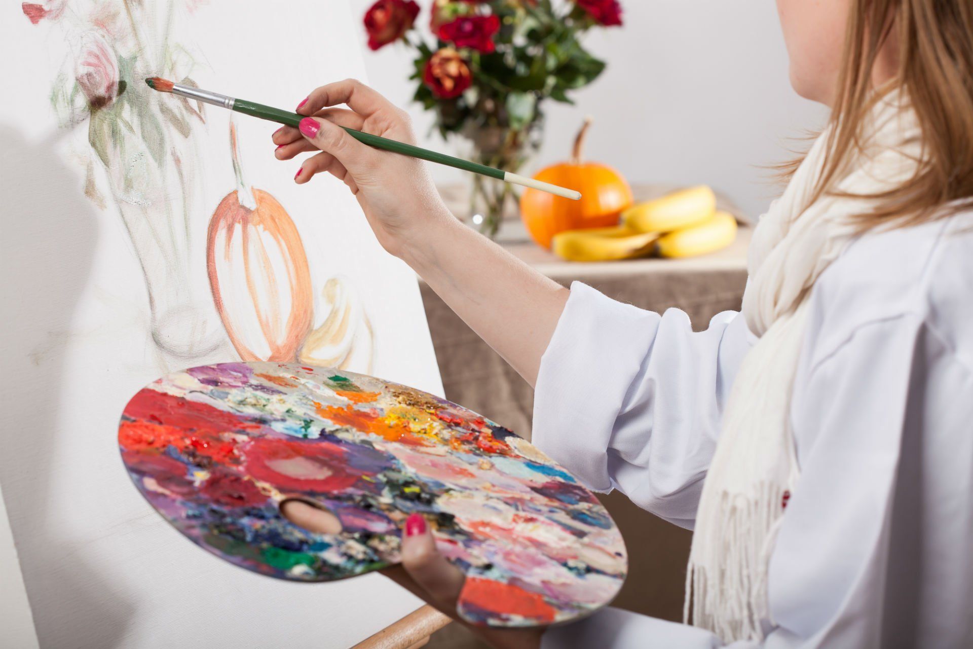 una donna con una tinozza di colori mentre dipinge