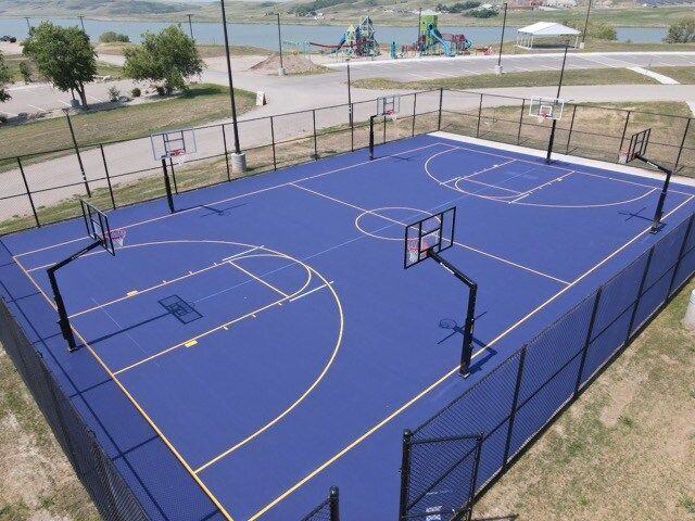 An aerial view of a basketball court with a fence around it