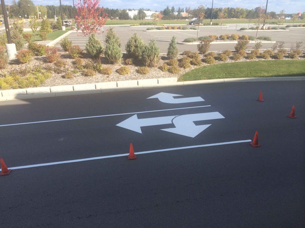 A parking lot with arrows painted on the road
