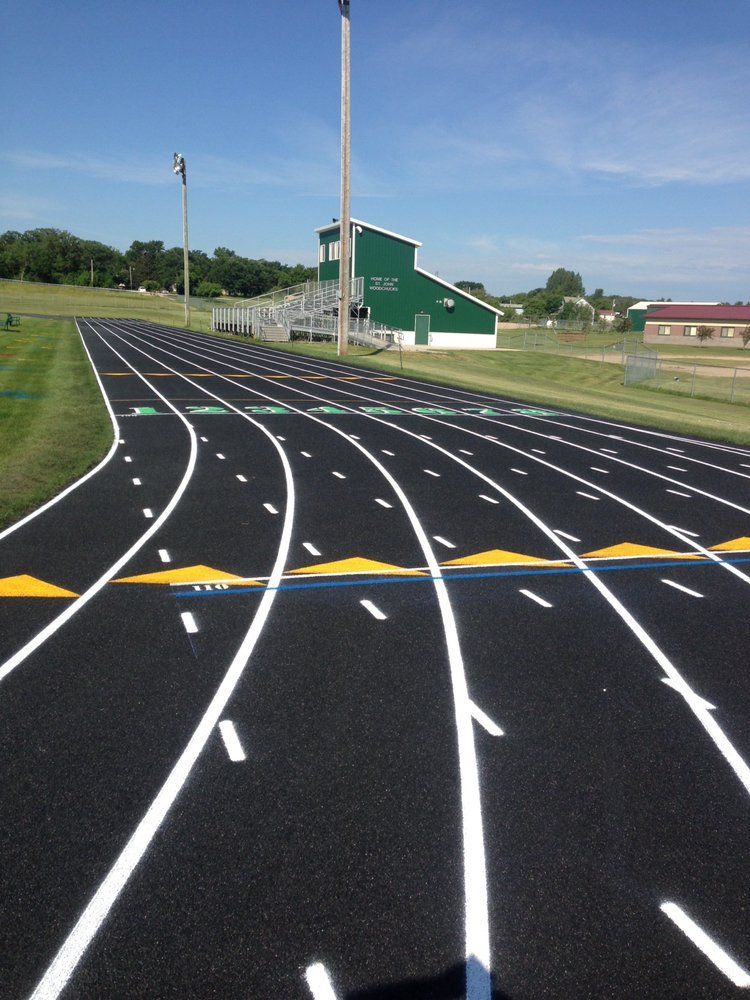 A track with a green building in the background