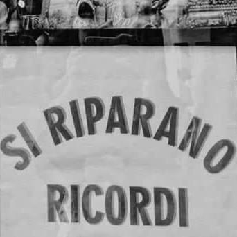 Una foto in bianco e nero di un cartello che dice si riparano ricordi.