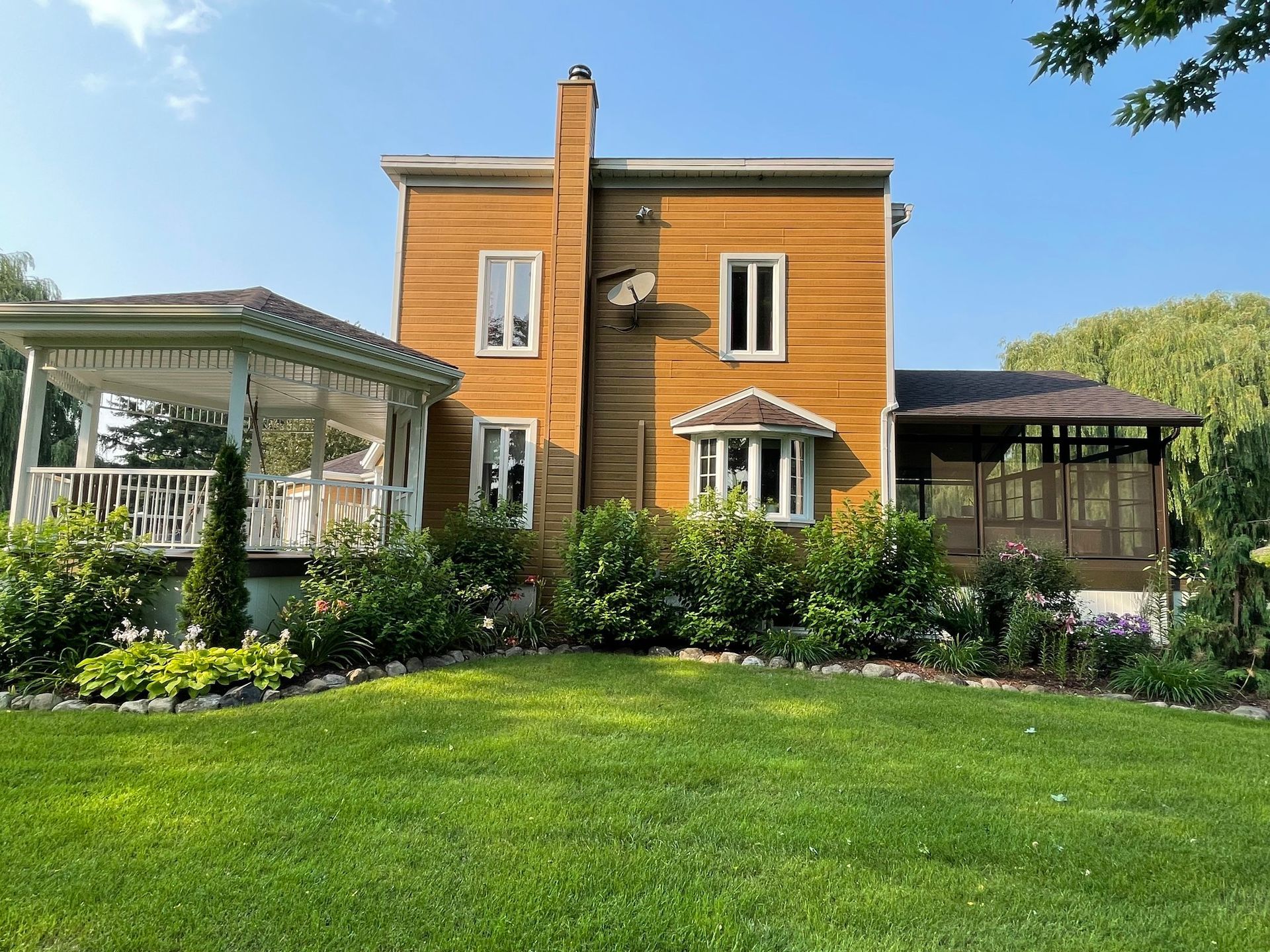Une grande maison avec un belvédère devant