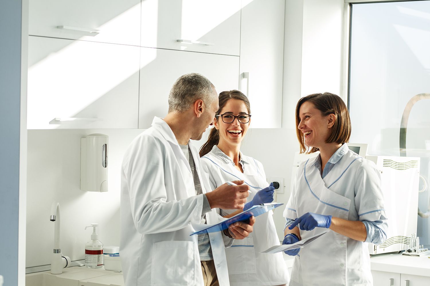 Medical staff in a clinic reviewing documents together.