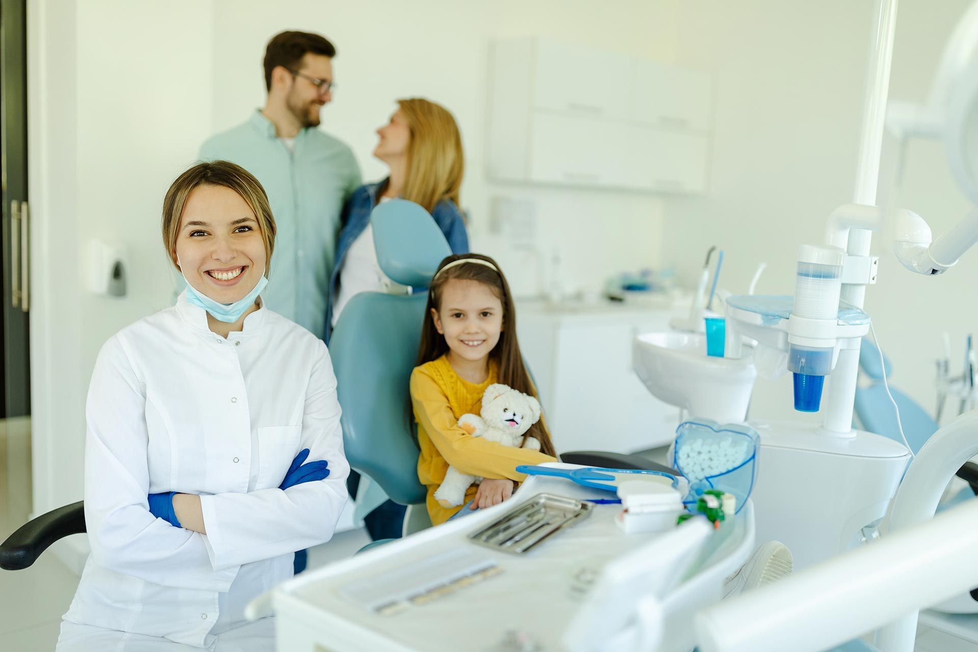 A family dentist providing care for a child during a dental visit.