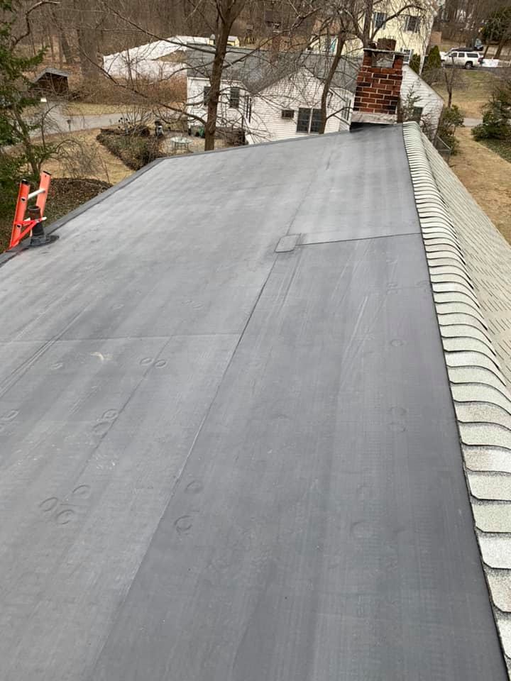 A close up of a roof with a ladder on top of it.