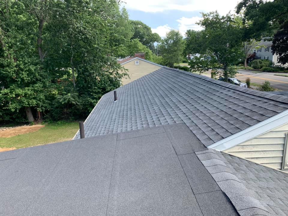 A roof of a house with trees in the background
