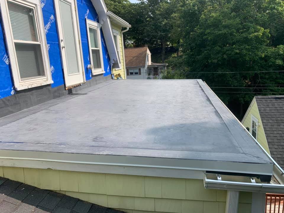 A roof of a house with a gutter on it.