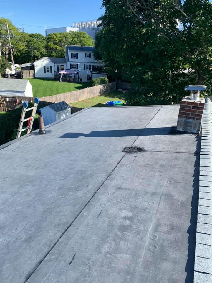 A roof with a chimney and a ladder on it